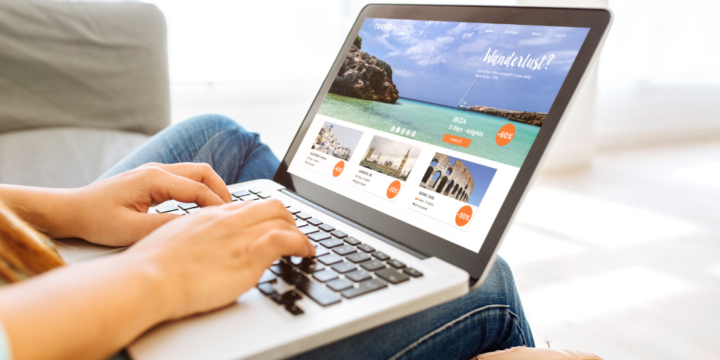Person looks at a travel planning website on their laptop.